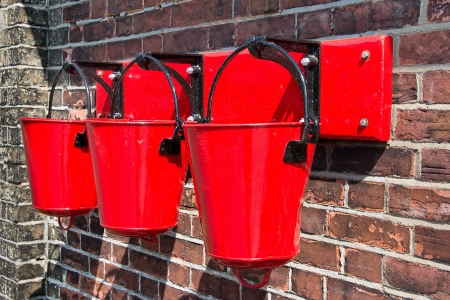Red fire buckets wall mounted 