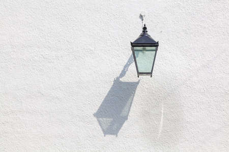 Decorative outdoor lamp with interesting cast shadowの写真素材