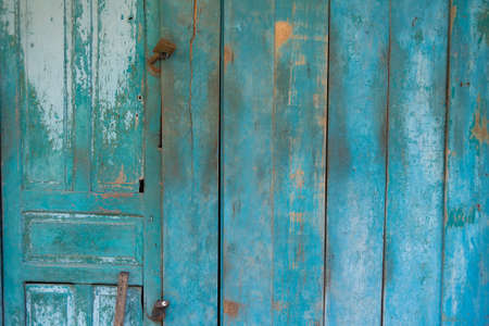 Blue weathered wooden door with rusty lockの写真素材