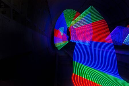 Multi-colored LED light used to create a pattern in a dark tunnel