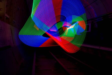 Multi-colored LED light used to create a pattern in a dark tunnel