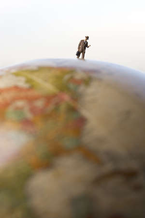 Business travel figure on globeの写真素材