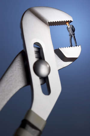 Business figurines in a clampの写真素材