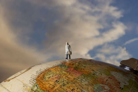 Business figurine placed on globeの写真素材