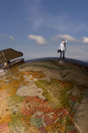 Business figurine placed on globeの写真素材