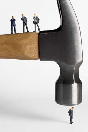 Business figurines placed on a hammerの写真素材