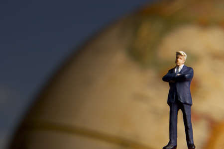 Business figurines and an earth globe.の写真素材