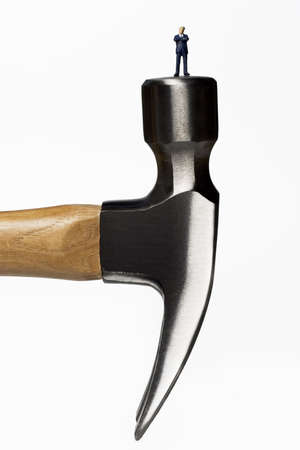 Business figurines placed on a hammerの写真素材