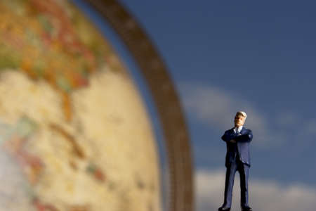 Business figurines and earth globe.の写真素材