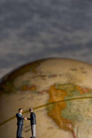 Business figurines and earth globe.の写真素材