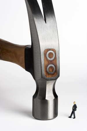 Business figurines placed with a hammer.の写真素材
