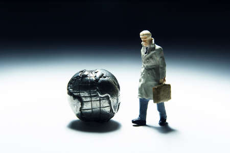 Business figurines and earth globe.の写真素材
