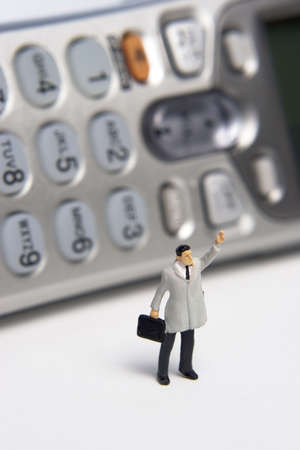 Business figures and portable phoneの写真素材