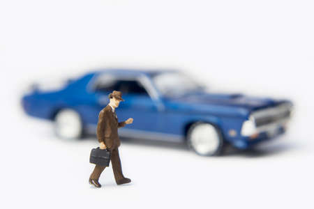 Business figurine and a toy carの写真素材