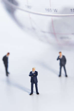 Business figurines and earth globe.の写真素材