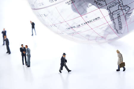 Business figurines and an earth globe.の写真素材