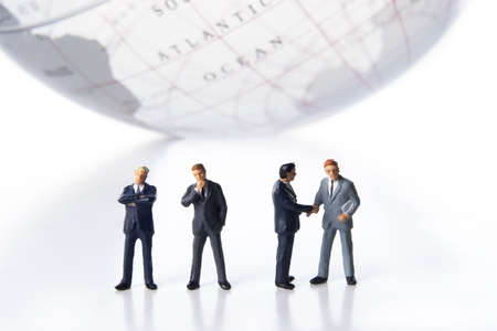 Business figurines and an earth globe.の写真素材