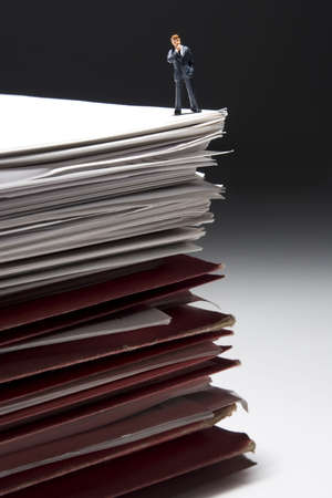 Business figures and stacks of papers and folders