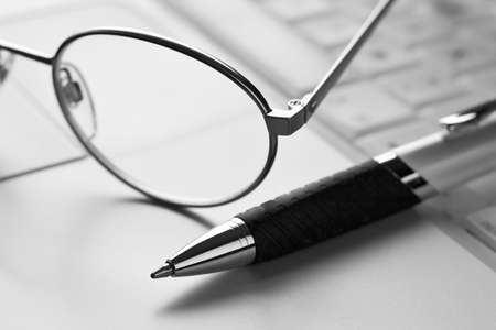Glasses, pen and laptopの写真素材