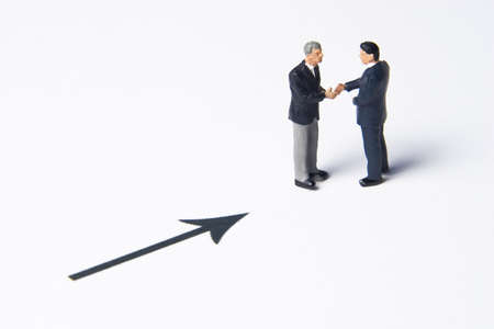 Business figures and arrowの写真素材