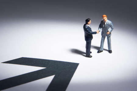 Business figures and arrowの写真素材