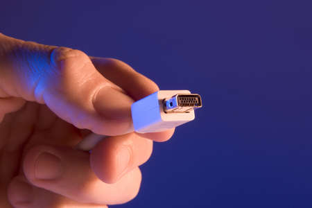 Hand holding a computer plugの写真素材