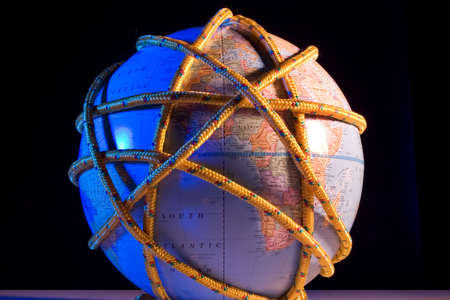 Earth globe wrapped with ropeの写真素材