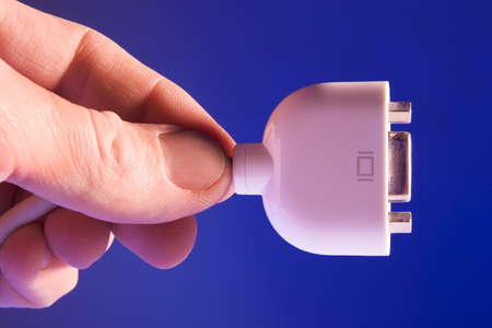 Hand holding a computer plugの写真素材