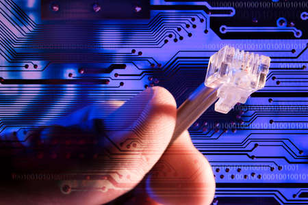 Composite of a hand and circuit board.の写真素材