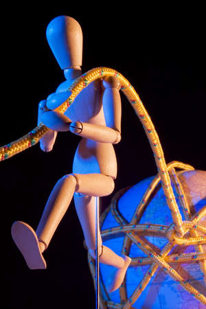 Artist mannequin pulling an earth globe with a ropeの写真素材
