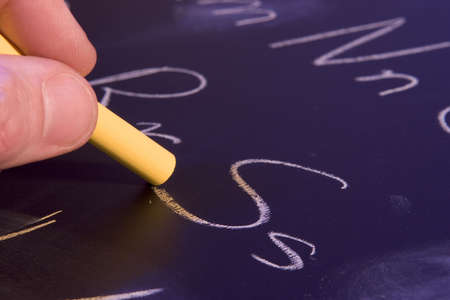 Writing the alphabet on a chalkboard 