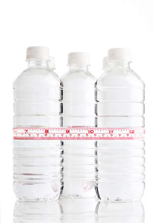 Water bottle wrapped with a tape measureの写真素材