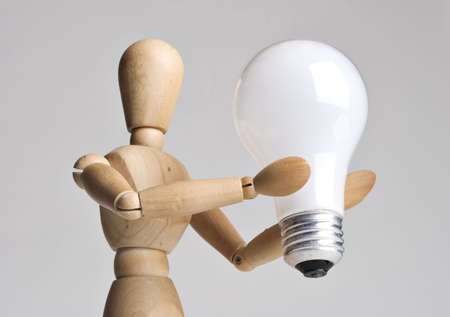 Mannequin holding a light bulb 