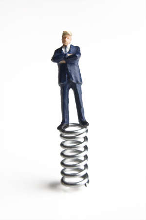 Businessman figurine standing on a springの写真素材