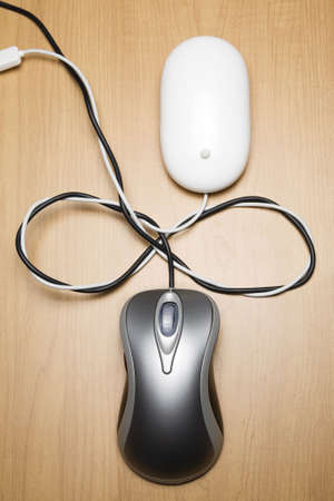 Two computer mouse cords tied togetherの写真素材