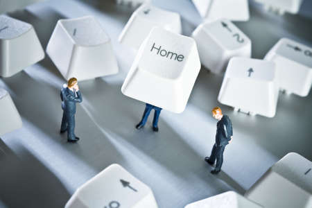 Business figurines placed with keys from a computer keyboard