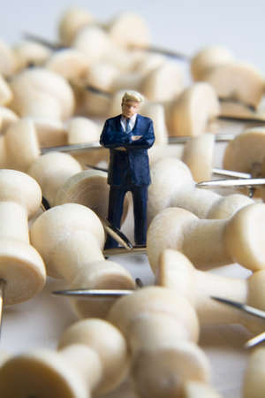 Businessman figurine placed with tacks の写真素材