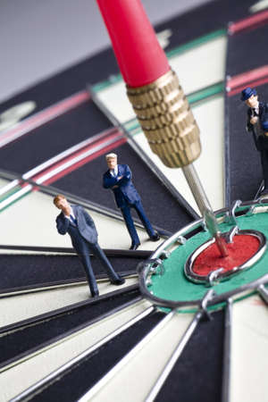 Businessman figurines placed on a dartboardの写真素材