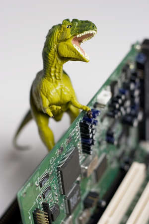 Dinosaur figurine with circuit board on whiteの写真素材
