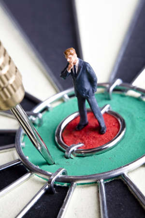 Businessman figurines placed on a dartboard