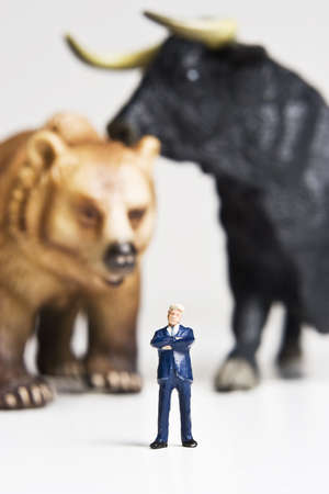 Business figurines placed with bull and bear figurines.の写真素材