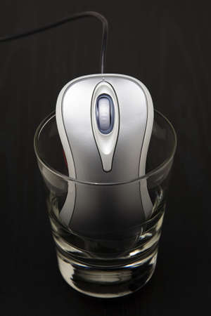 Computer mouse in a glassの写真素材