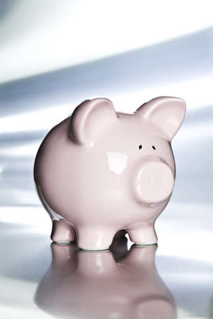 Piggy bank on a metal tabletopの写真素材