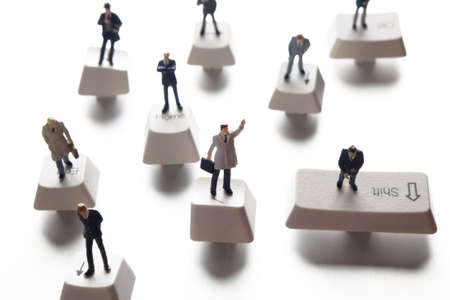 Business figurine placed on computer keys の写真素材