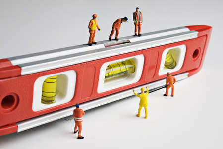 Worker figurines and a levelの写真素材