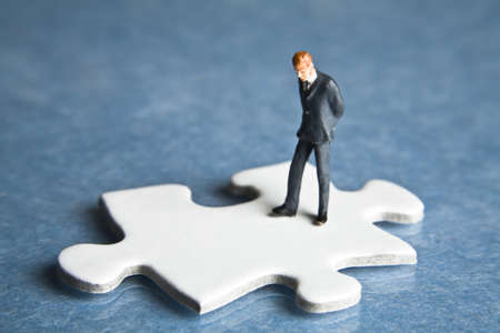 Businessmen figurines and puzzle pieces 
