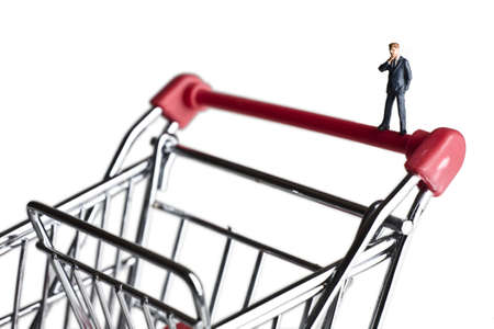 Businessman figurines on a shopping cartの写真素材