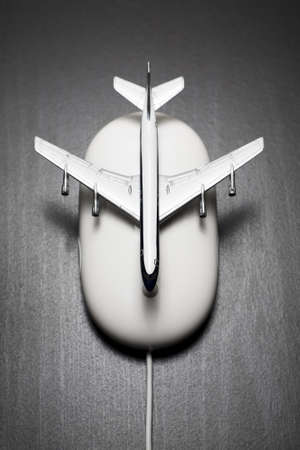 Toy airplane on computer mouseの写真素材