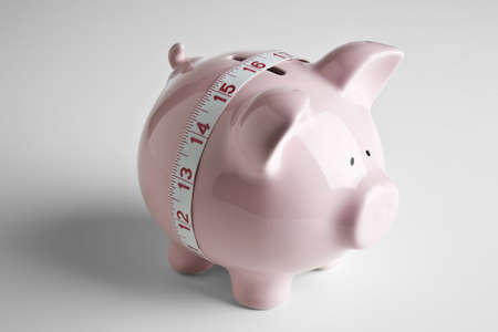 Piggy bank and tape measureの写真素材