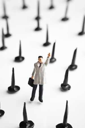 Businessman figurine with tacks の写真素材